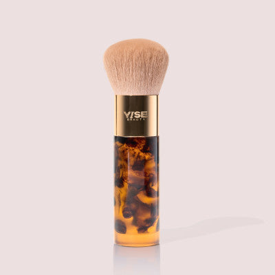 The Finisher One & Done Brush, a domed kabuki brush with a gold band and tortoiseshell handle