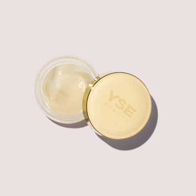 Open jar of Like A Gloss Hydrating Lip Mask beside its gold lid