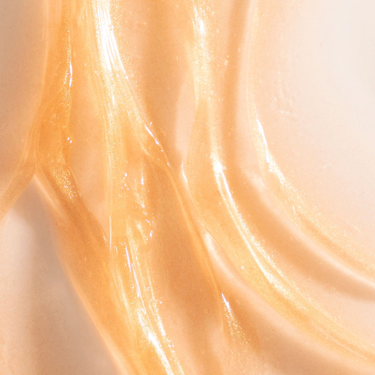Close-up of Take It Off Gel-Oil Cleanser's shimmering golden texture.