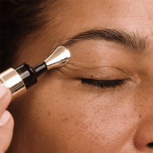Massaging the brow bone with Wide Awake Brightening Eye Cream's metal applicator.