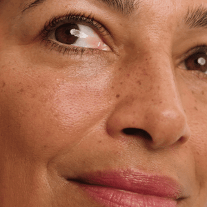 Close-up of smooth, glowing under-eye skin after applying Wide Awake Brightening Eye Cream.